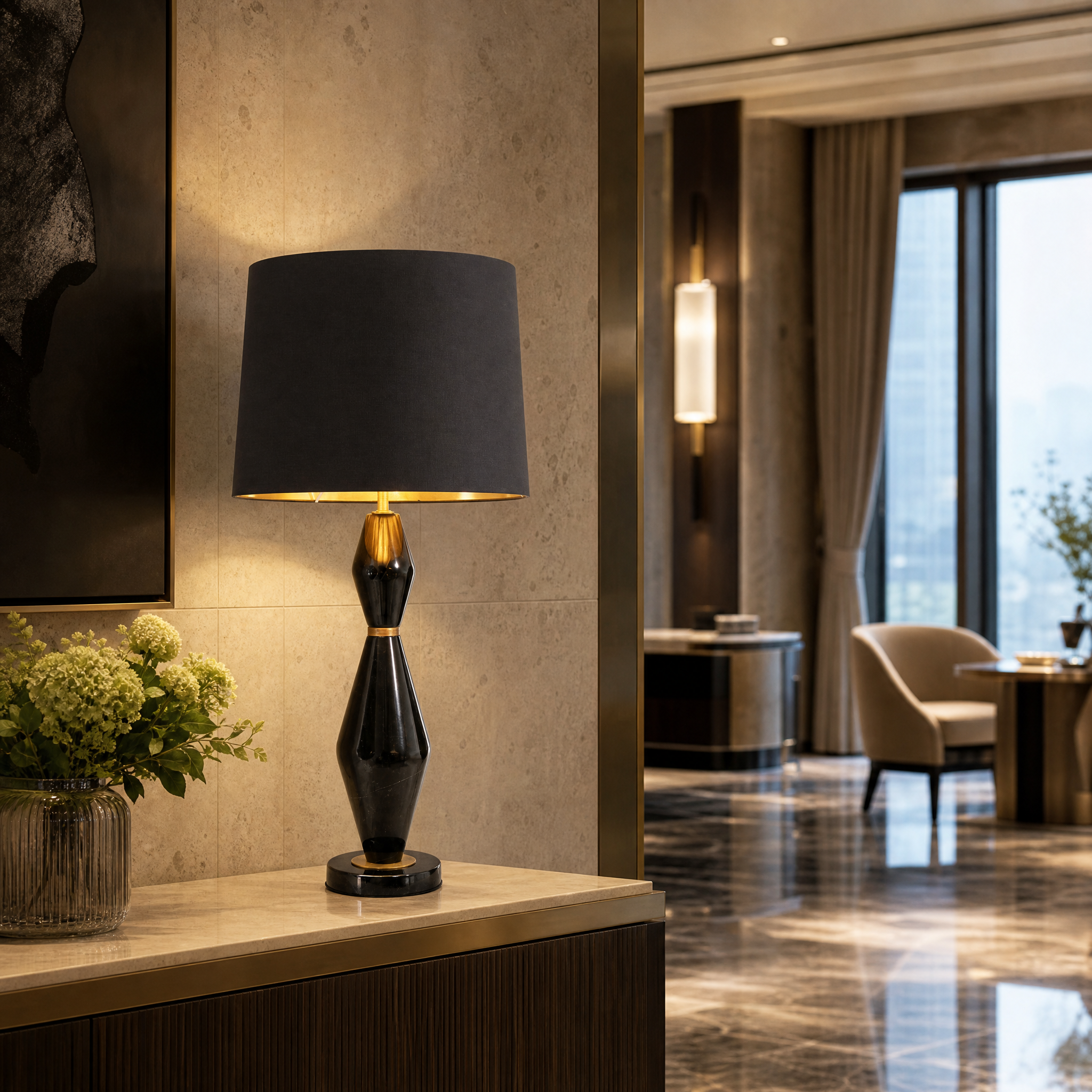 A row of VORELLI Thelora black marble table lamps with brass accents adding sophisticated contrast to a contemporary hotel lounge bar.
