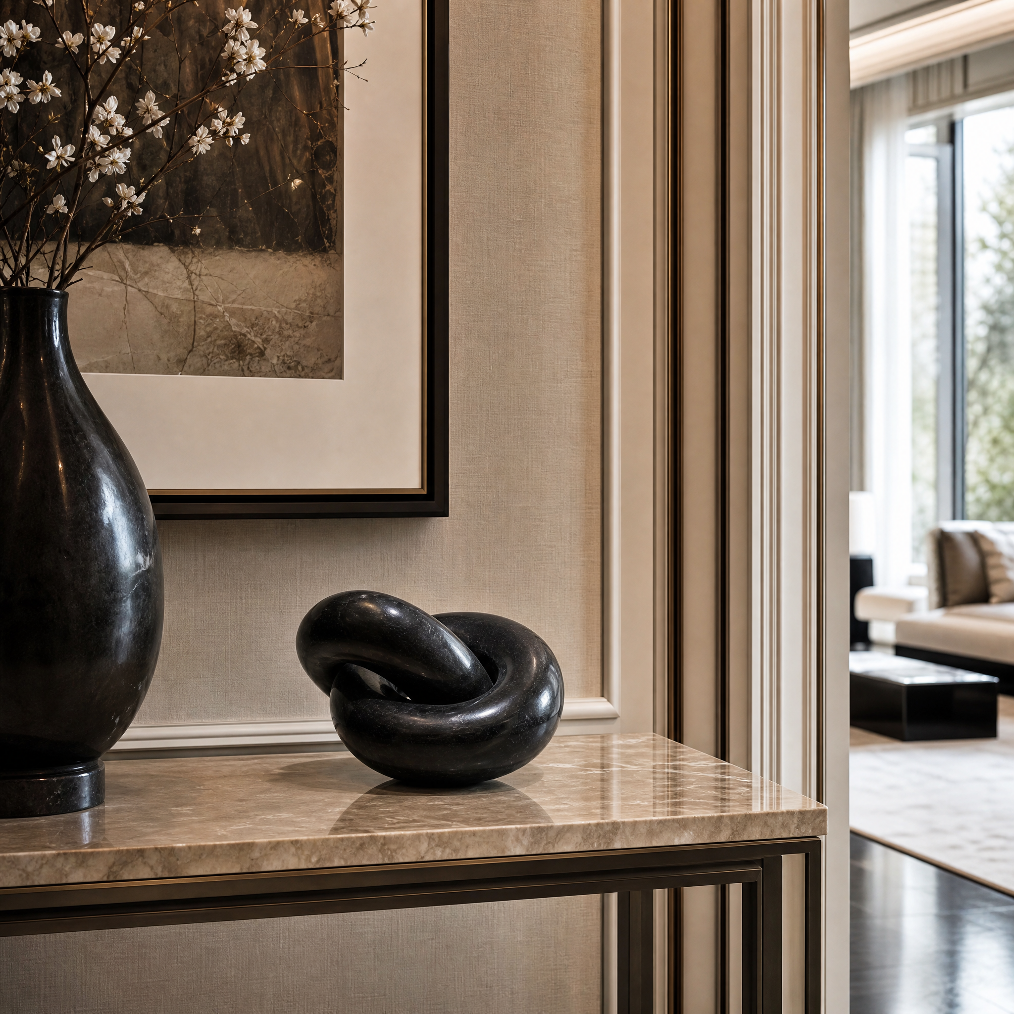 The VORELLI Torrino Black Link Decor styled on a modern living room coffee table, showcasing the interlocking polished marble knot design in a contemporary residential setting.
