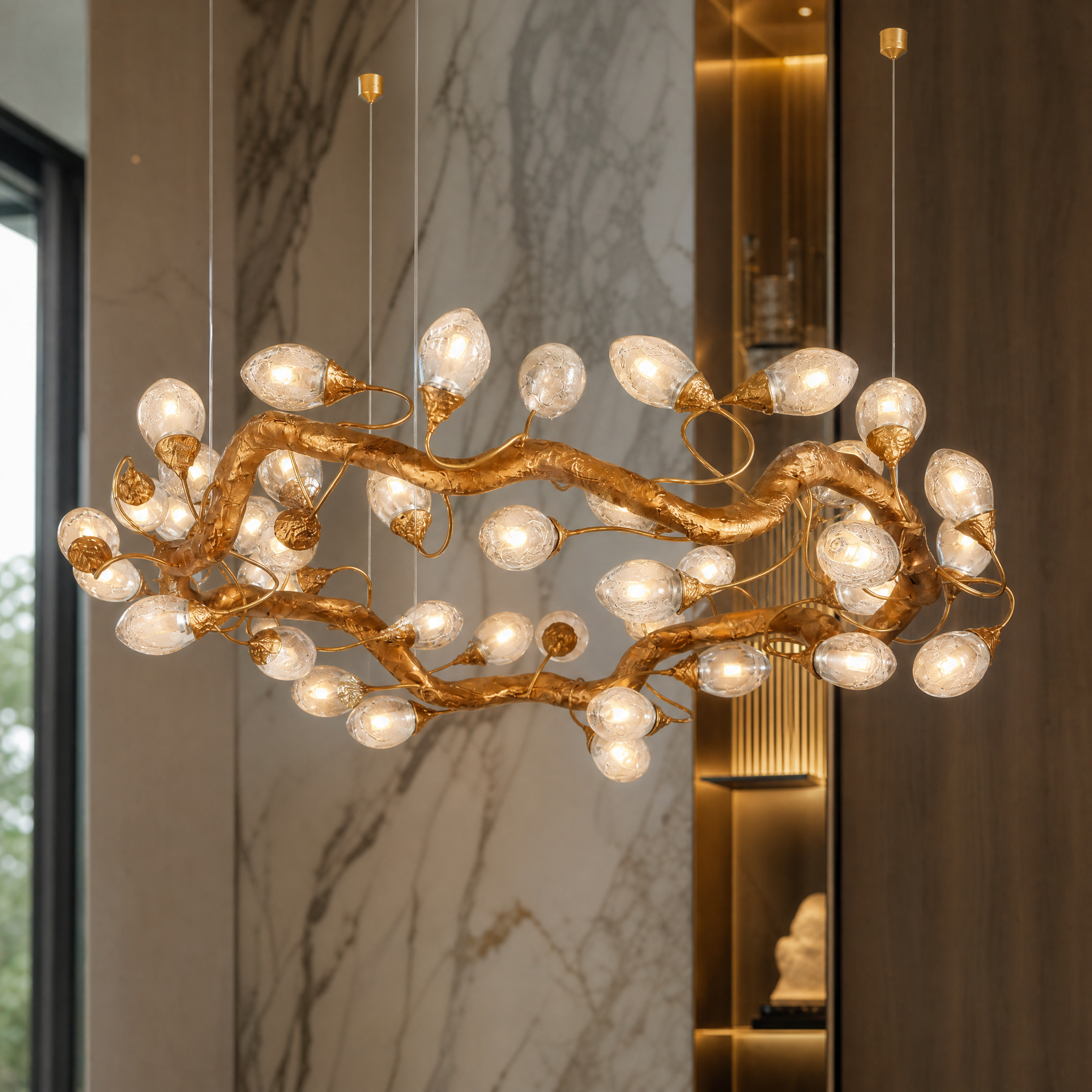 Close up view of the Tremezzo chandelier showcasing artisan sculptural arms and softly glowing illuminated glass elements
