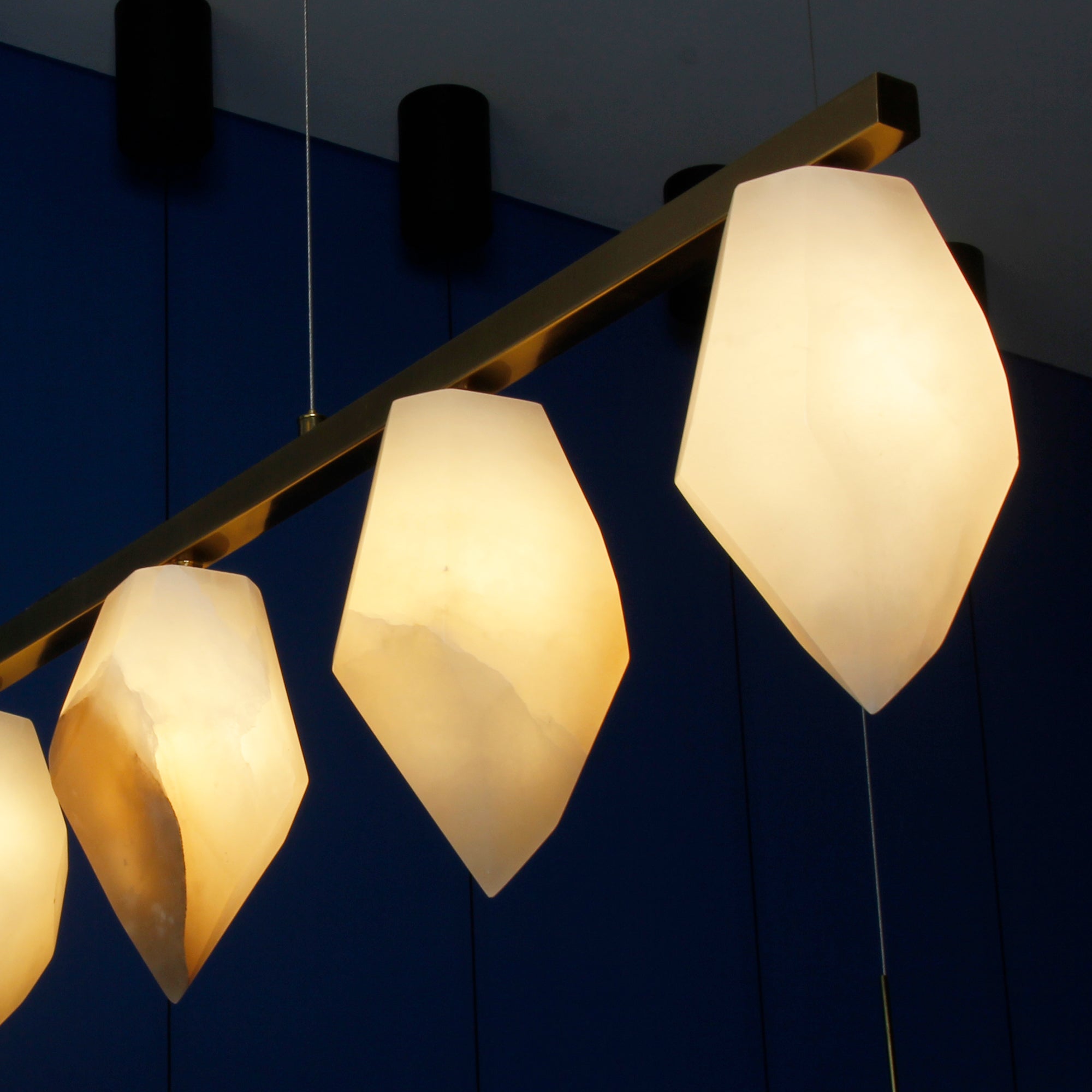 Tuscana marble rectangular chandelier creating warm ambient lighting in a luxury interior