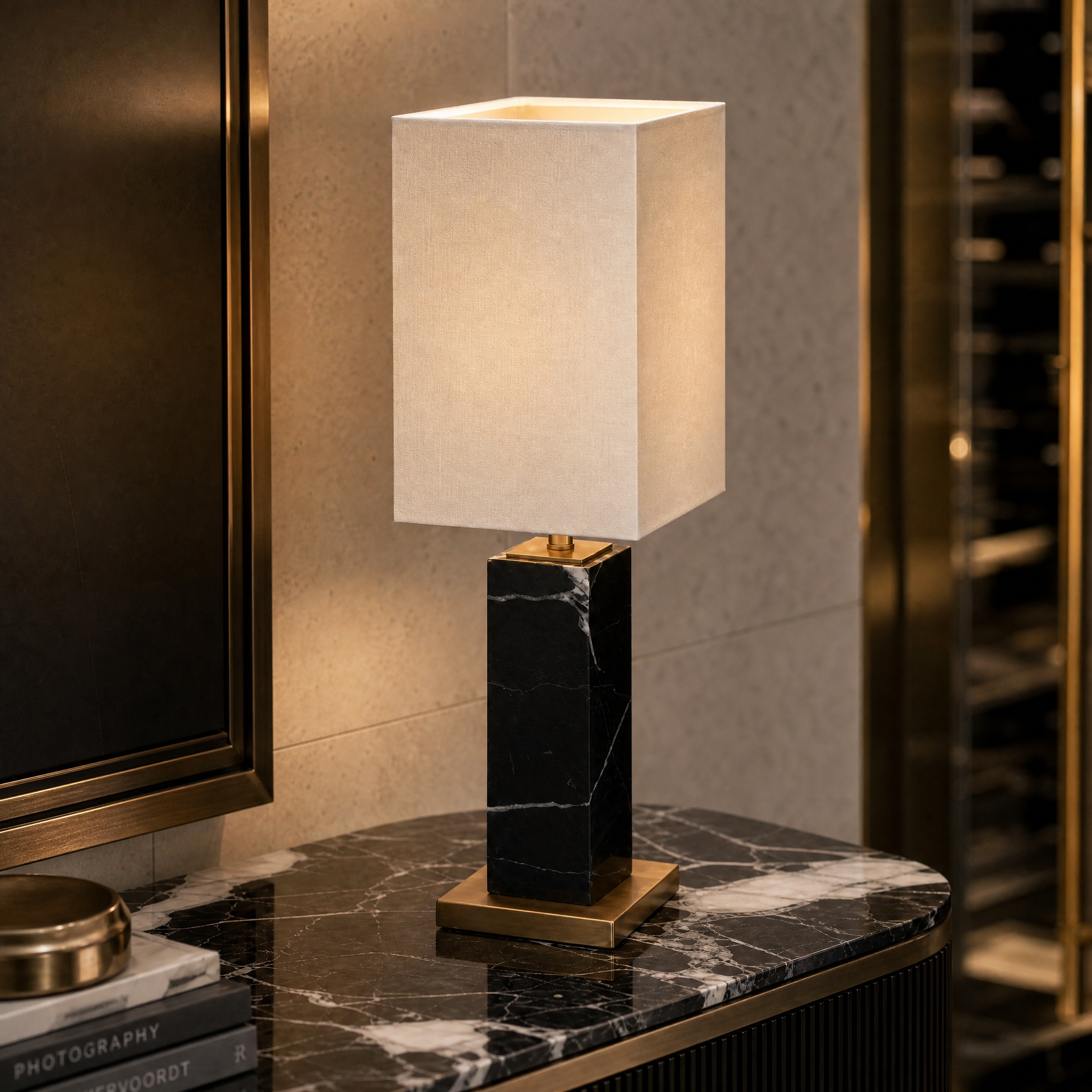 Close-up detail of the Valdoro marble table lamp featuring sleek black marble base and antique brass accents