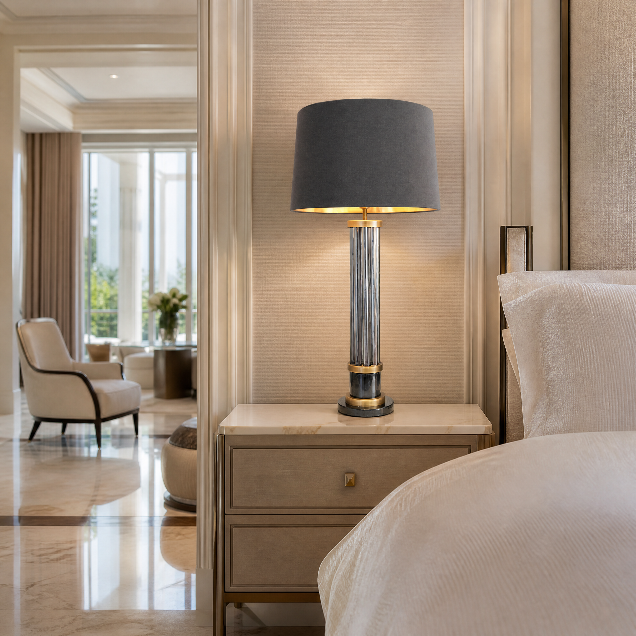 The Valenro Marble Table Lamp by VORELLI styled on a contemporary sideboard in a luxury residential living room, casting a warm, sophisticated glow.