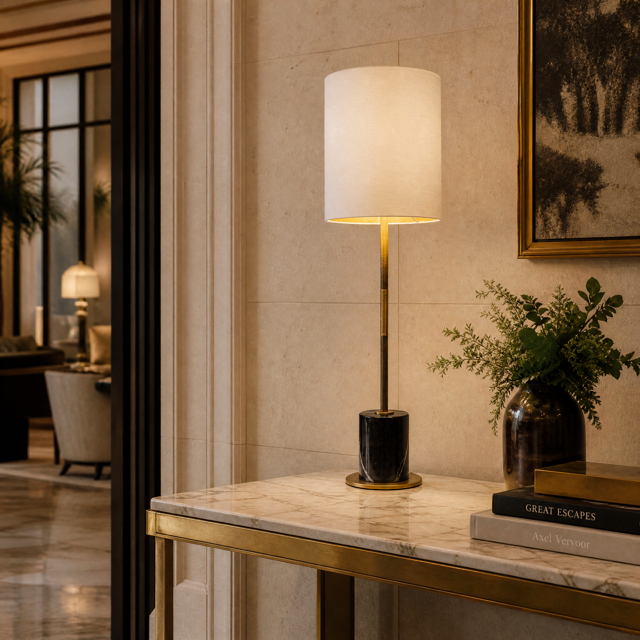 The elegant silhouette of the Velmoro Marble Table Lamp casting a warm, inviting glow on a concierge desk in a sophisticated hospitality interior.