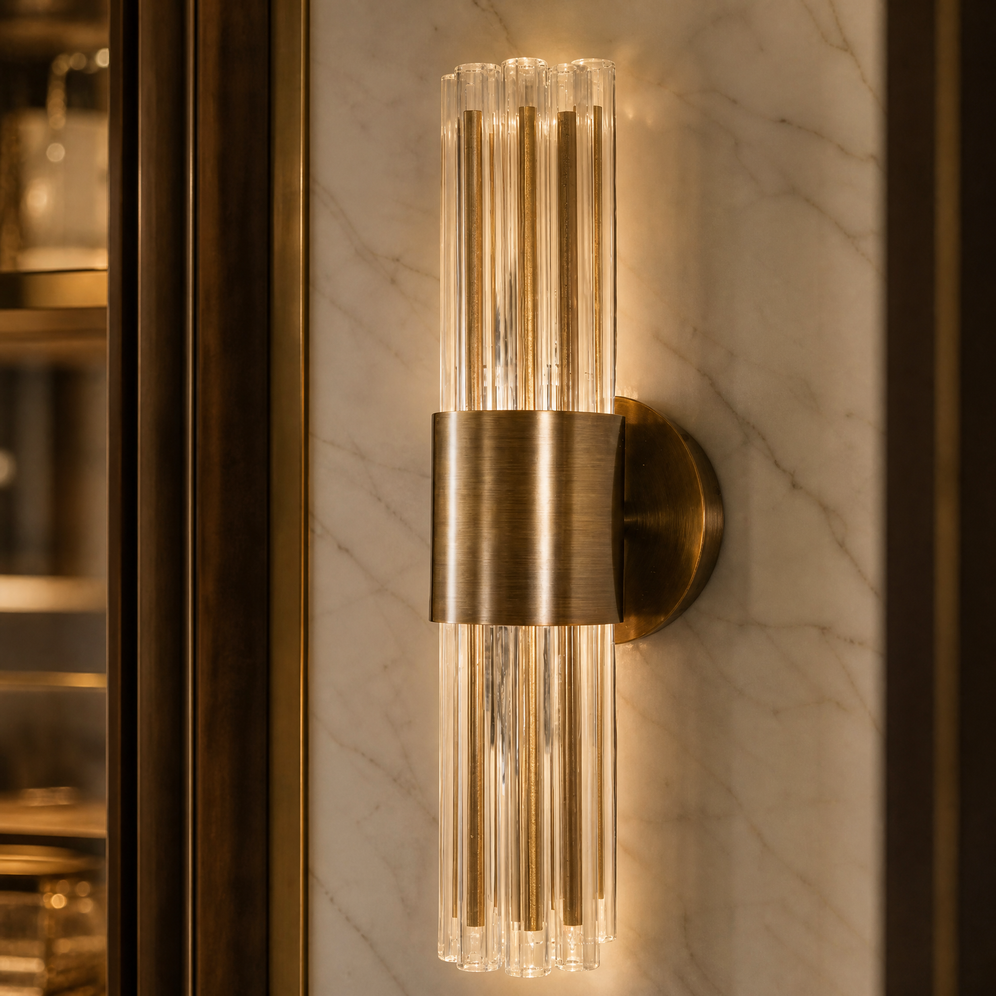 A detailed closeup shot of the VORELLI Victoria Wall Light, showcasing the exquisite vertical glass tubes designed to softly diffuse light.