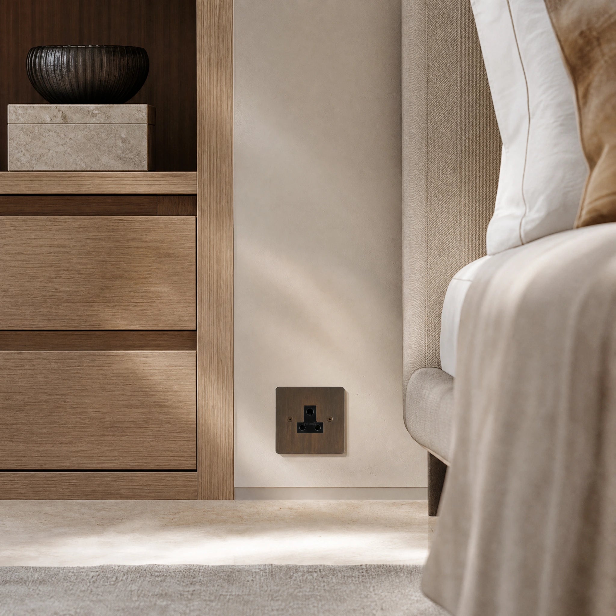 Luxury antique brass 5a socket installed within bespoke bedside joinery or low-level wall beside a luxury seating area in a UHNW interior by VORELLI®.