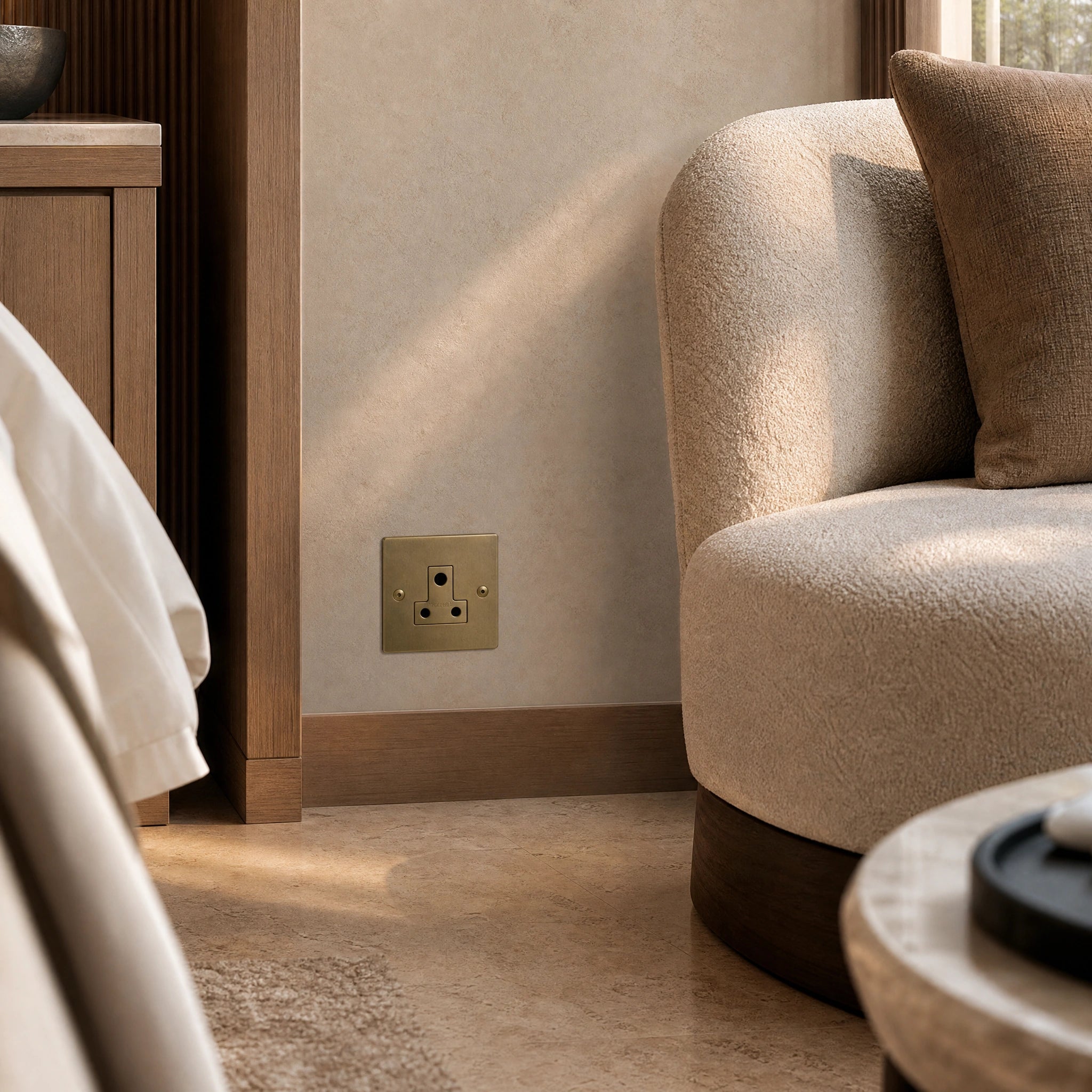 Luxury antique brass 5a socket installed within bespoke bedside joinery or low-level wall beside a luxury seating area in a UHNW interior by VORELLI®.