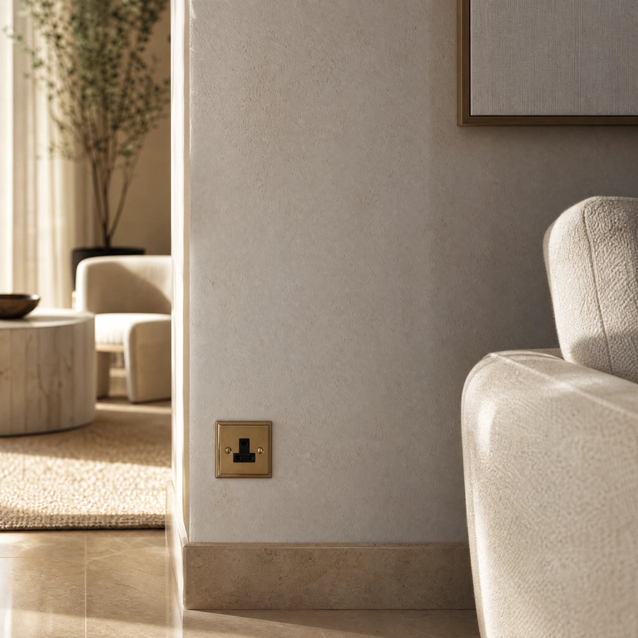Luxury antique brass 5a socket installed within bespoke bedside joinery or low-level wall beside a luxury seating area in a UHNW interior by VORELLI®.