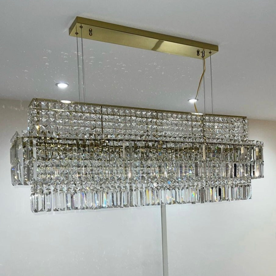 VORELLI® Abruzzi rectangular chandelier featuring diamond cut crystal prisms suspended from a rectangular ceiling plate, designed for luxury dining rooms and statement interiors.