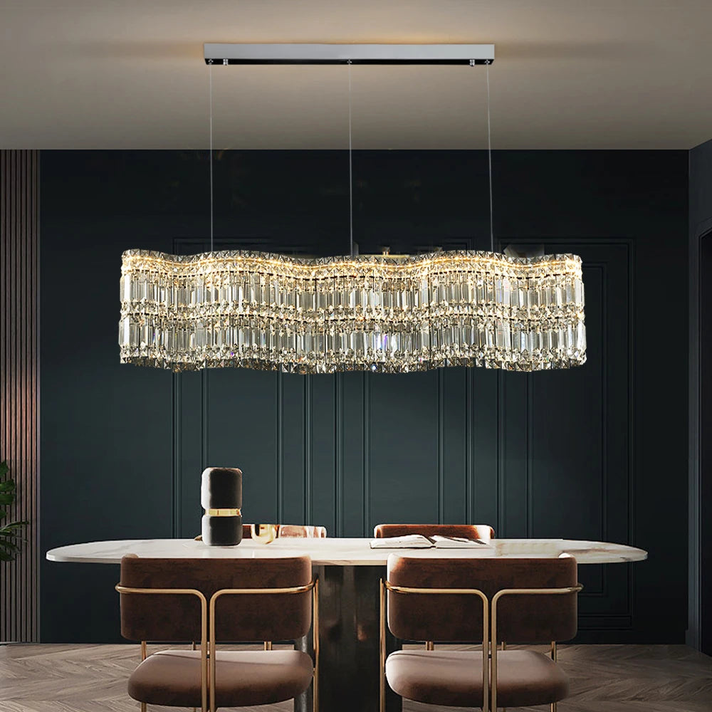 VORELLI® Abruzzi Rectangular Chandelier II above a modern dining table with dark green wall backdrop
