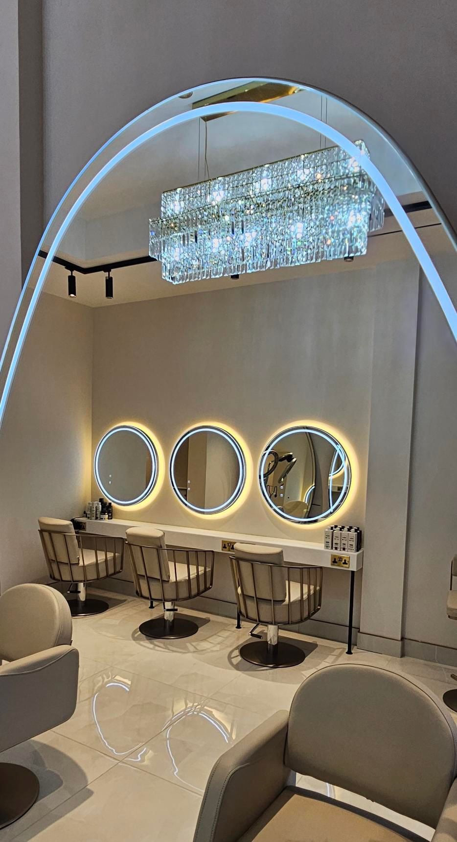Abruzzi rectangular chandelier by VORELLI® illuminating a high-end commercial interior with diamond cut crystals and refined contemporary styling