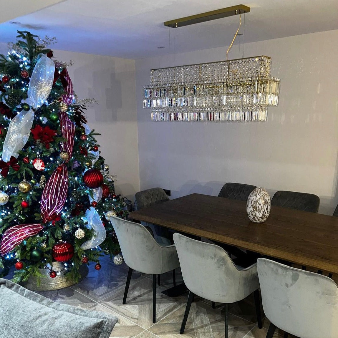 Abruzzi rectangular chandelier by VORELLI® installed above a luxury dining table, featuring diamond cut crystal detailing in an elegant residential interior