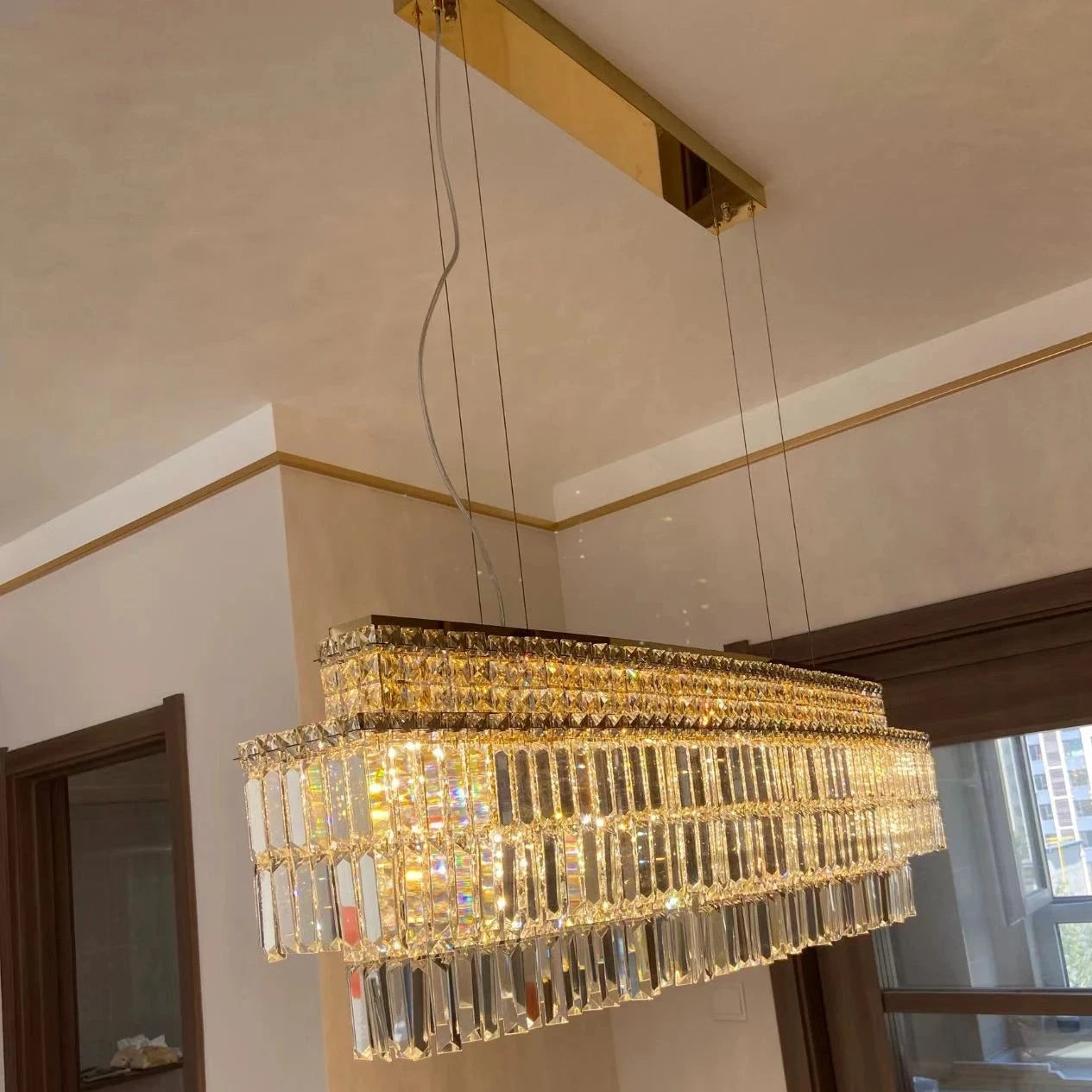 Side view of VORELLI® Abruzzi Rectangular Chandelier in a luxury interior with wooden accents