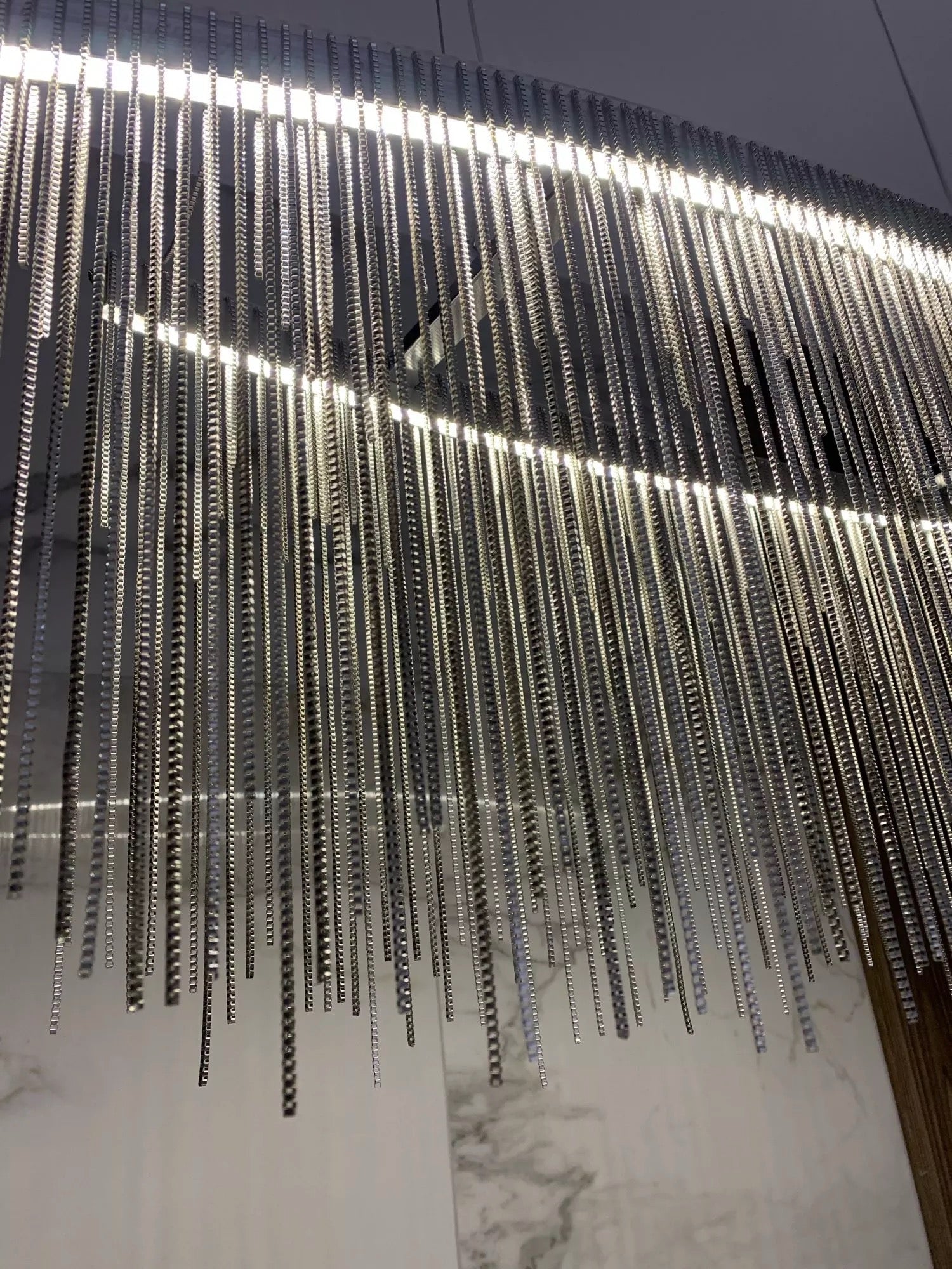 VORELLI® Adlington Arc rectangular chandelier featuring cascading diamond cut chain detailing, creating a refined luxury statement for modern dining and living spaces