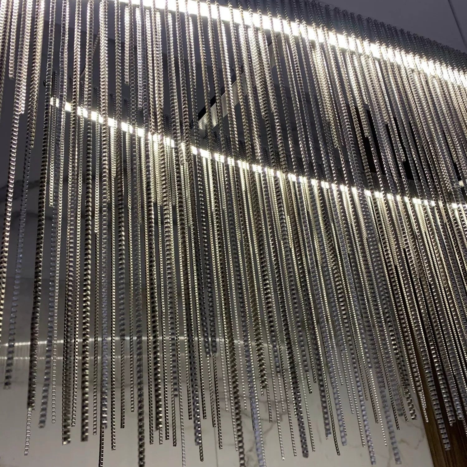 VORELLI® Adlington Arc rectangular chandelier featuring cascading diamond cut chain detailing, creating a refined luxury statement for modern dining and living spaces