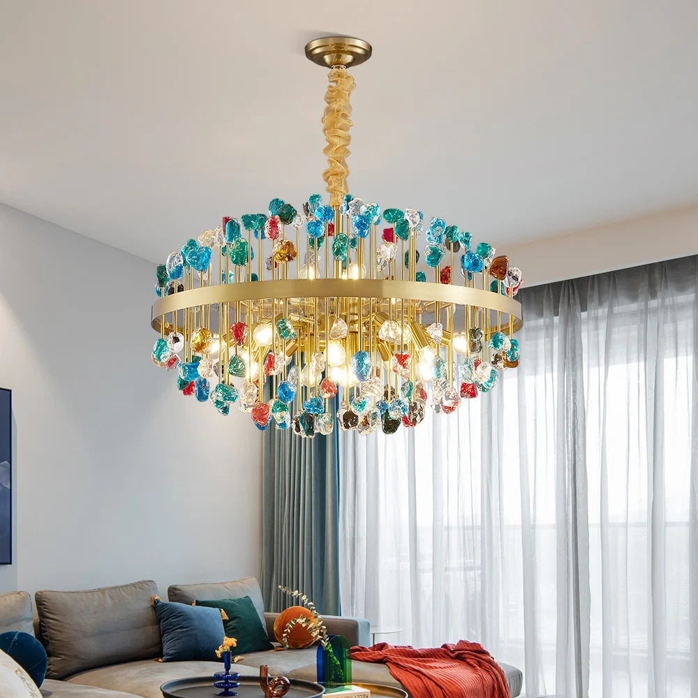 Blue crystal version of the Alytus chandelier hanging in a modern living space with natural light.