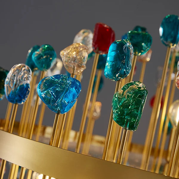 Detail of the Alytus chandelier featuring gold frame and vibrant coloured crystal tops.