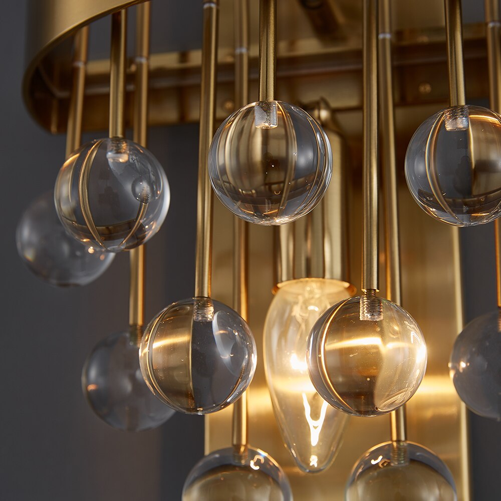 Detailed image of the Alytus Wall Light showing the textured crystal composition and brushed gold finish.