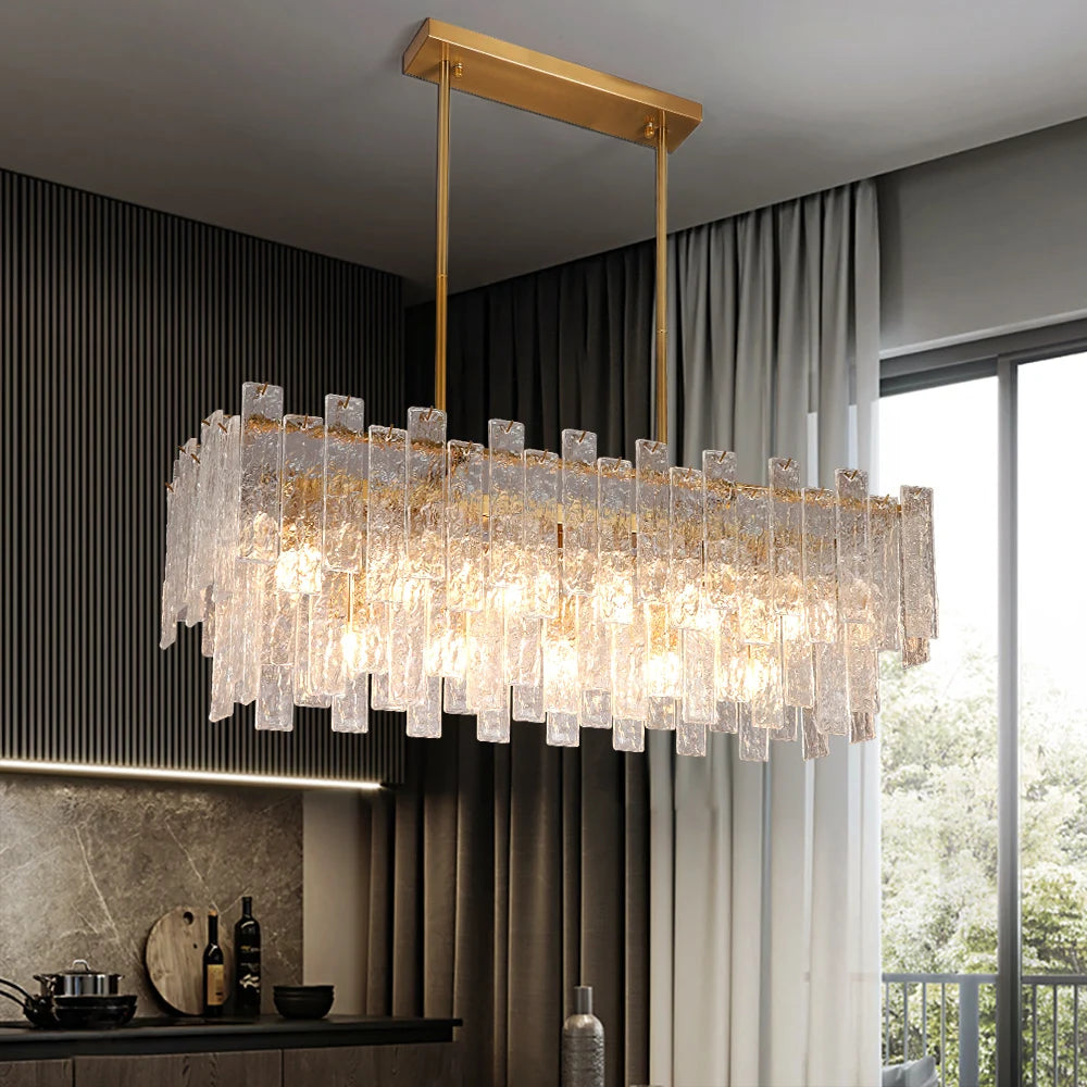 Ambani Rectangular Chandelier with layered cracked glass panels suspended above a modern dining table, enhancing the interior with warm lighting.