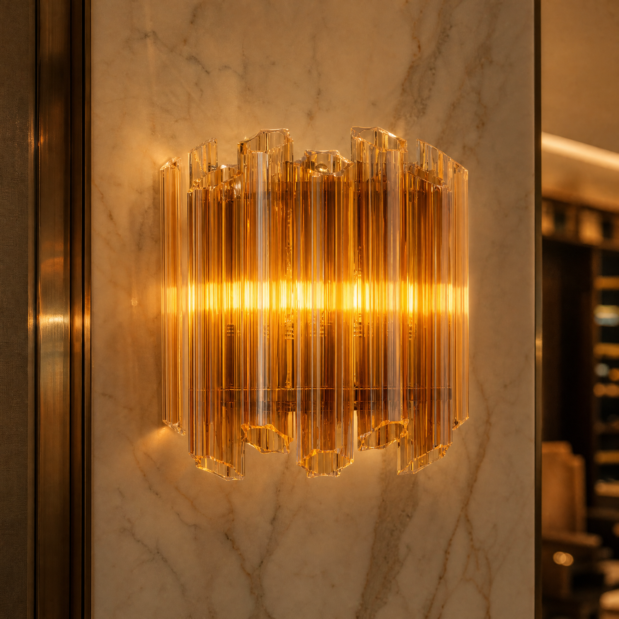 Macro closeup of the Amber Palermino wall light, highlighting the intricate hexagonal amber glass tubes suspended from a premium nickel-plated iron frame.
