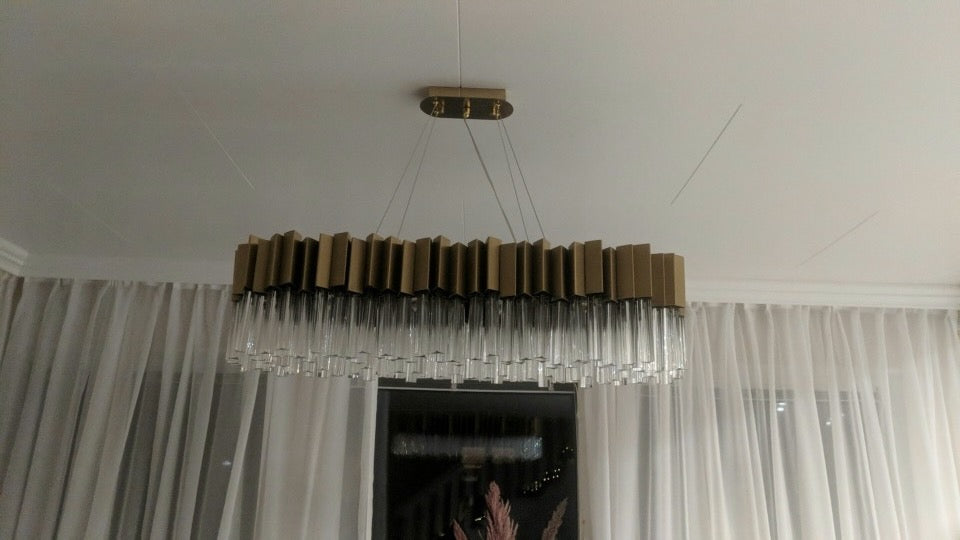 VORELLI® Antilia rectangular chandelier installed in a luxury interior, featuring a linear arrangement of crystal rods with refined ambient illumination.