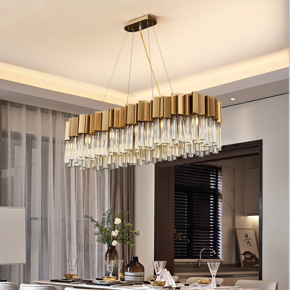 Antilia Rectangular Chandelier suspended above a modern dining table, showcasing its geometric design and radiant crystal bars.