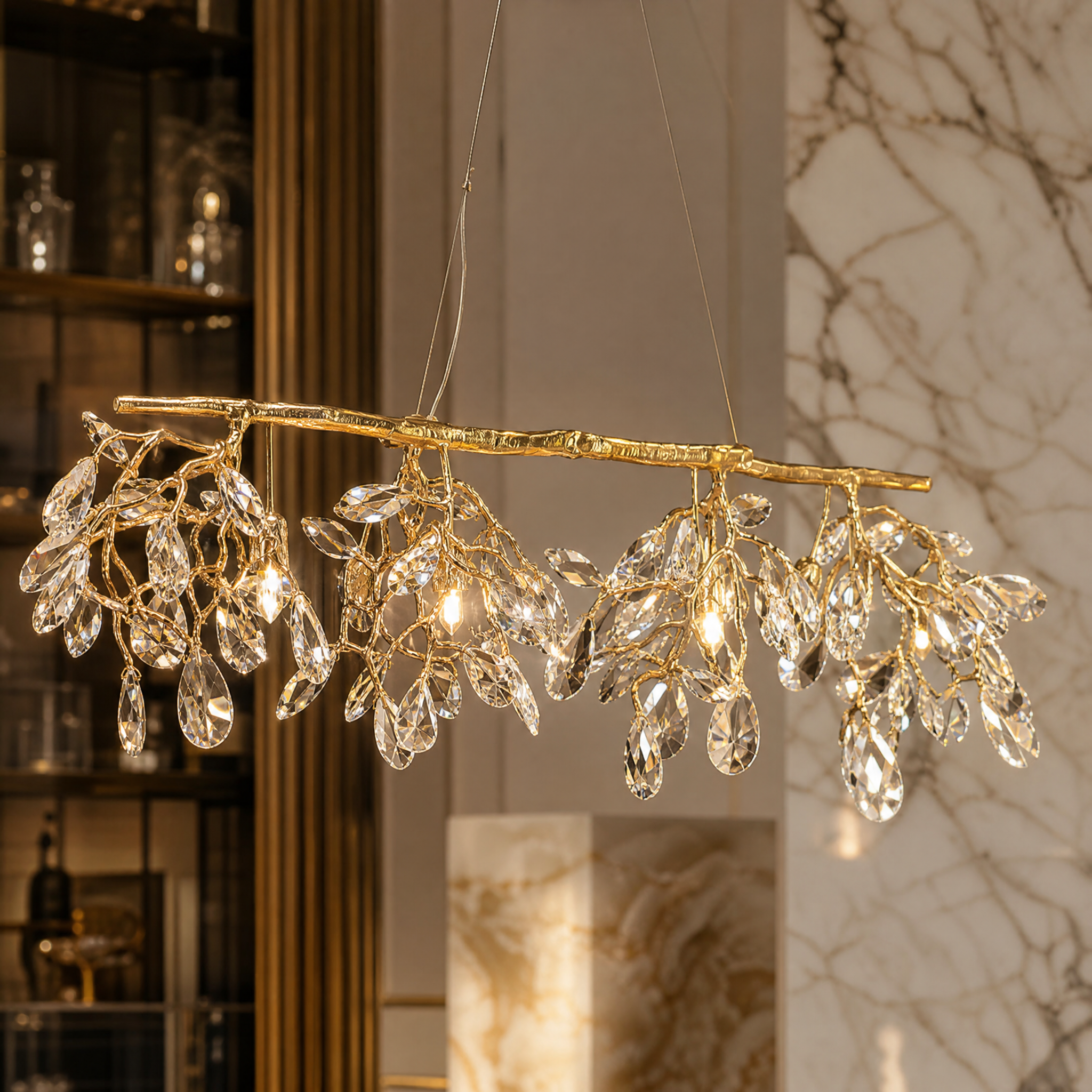 Macro view of the VORELLI Arboré chandelier's sculptural gold branch frame and precision diamond-cut faceted crystals.