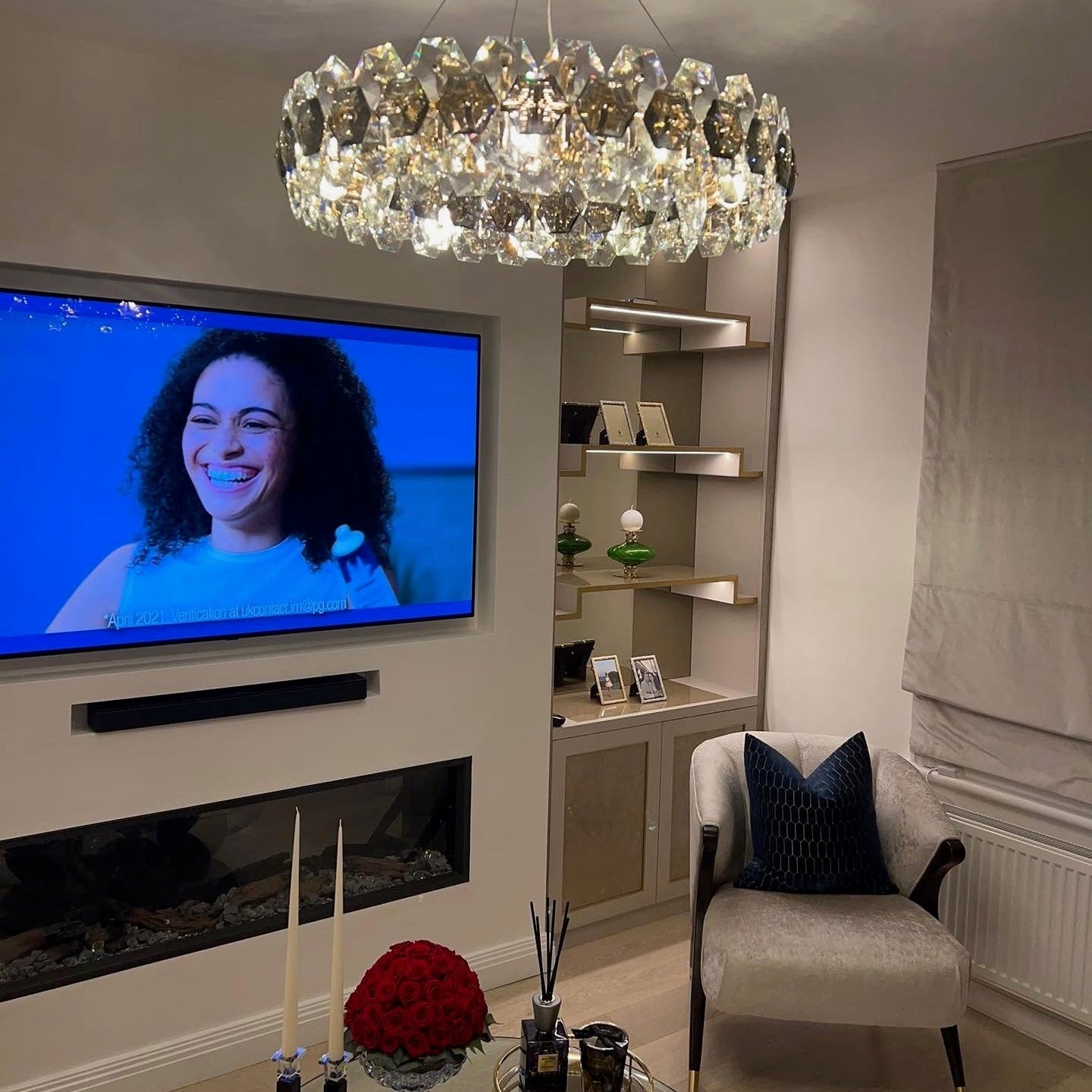 Astoria circular chandelier by VORELLI® illuminating a luxury living room with faceted crystal detailing