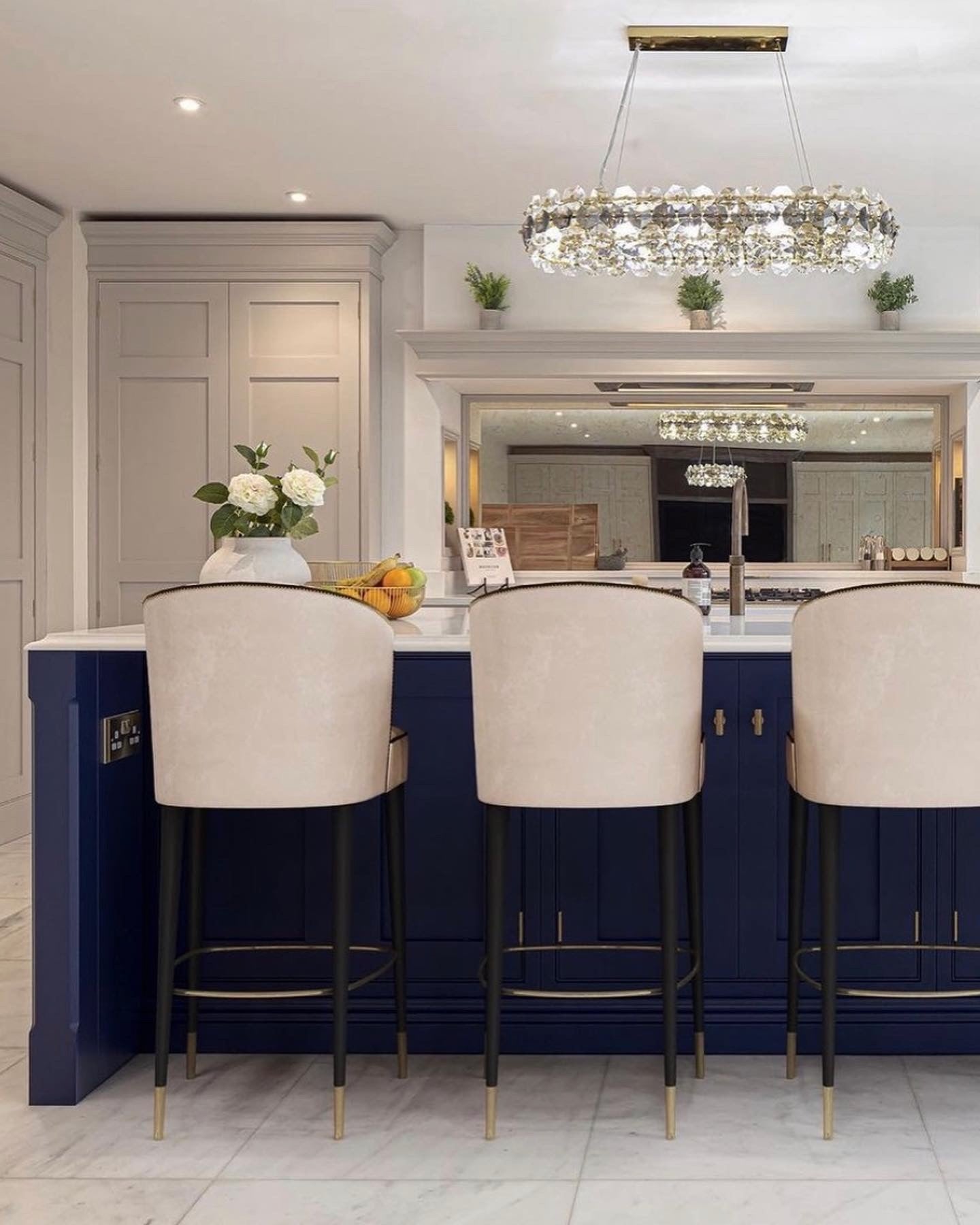 Astoria rectangular chandelier positioned above a luxury kitchen island in a spacious open-plan interior
