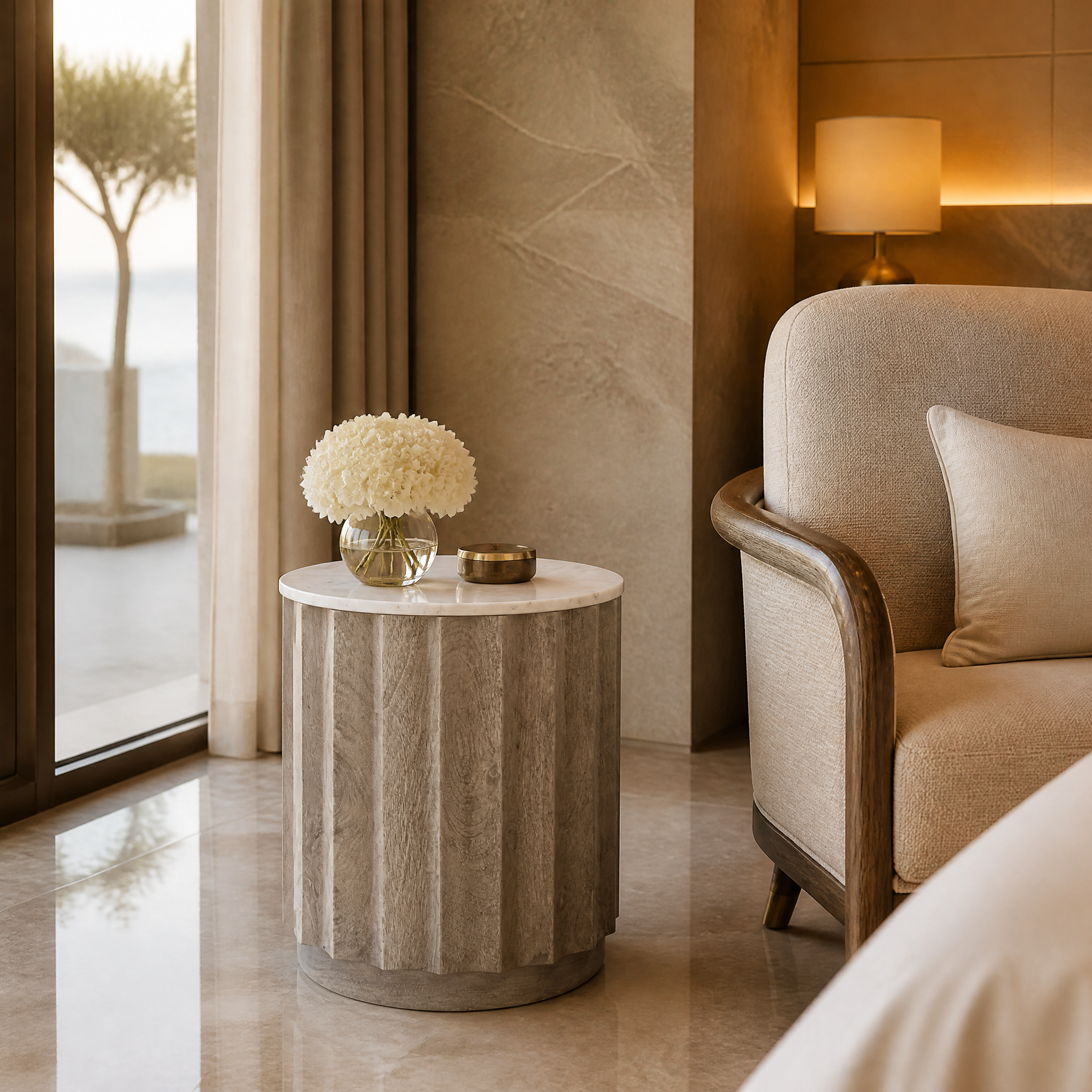 The Astreva stonewash fluted side table by VORELLI adding sophisticated architectural character to a luxury hospitality lounge or hotel lobby.