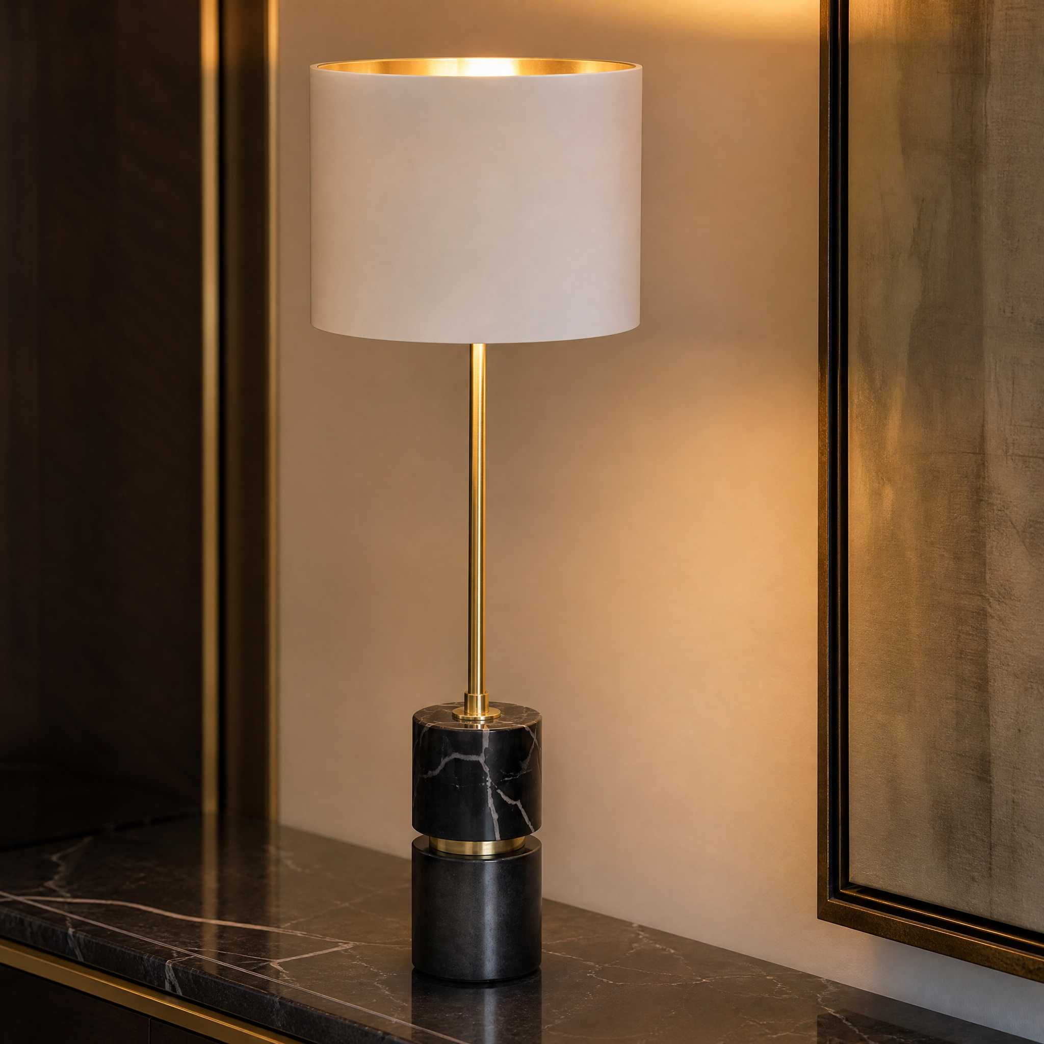 A detailed closeup of the VORELLI Aurevia table lamp showcasing the unique veining of the sculpted black marble base and refined antique brass detailing.