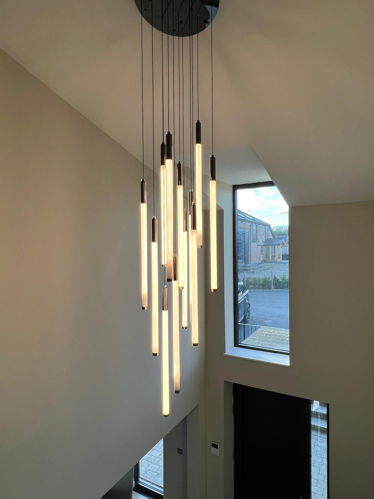 Avezzano staircase pendant light installed in a luxury hallway creating vertical ambient illumination
