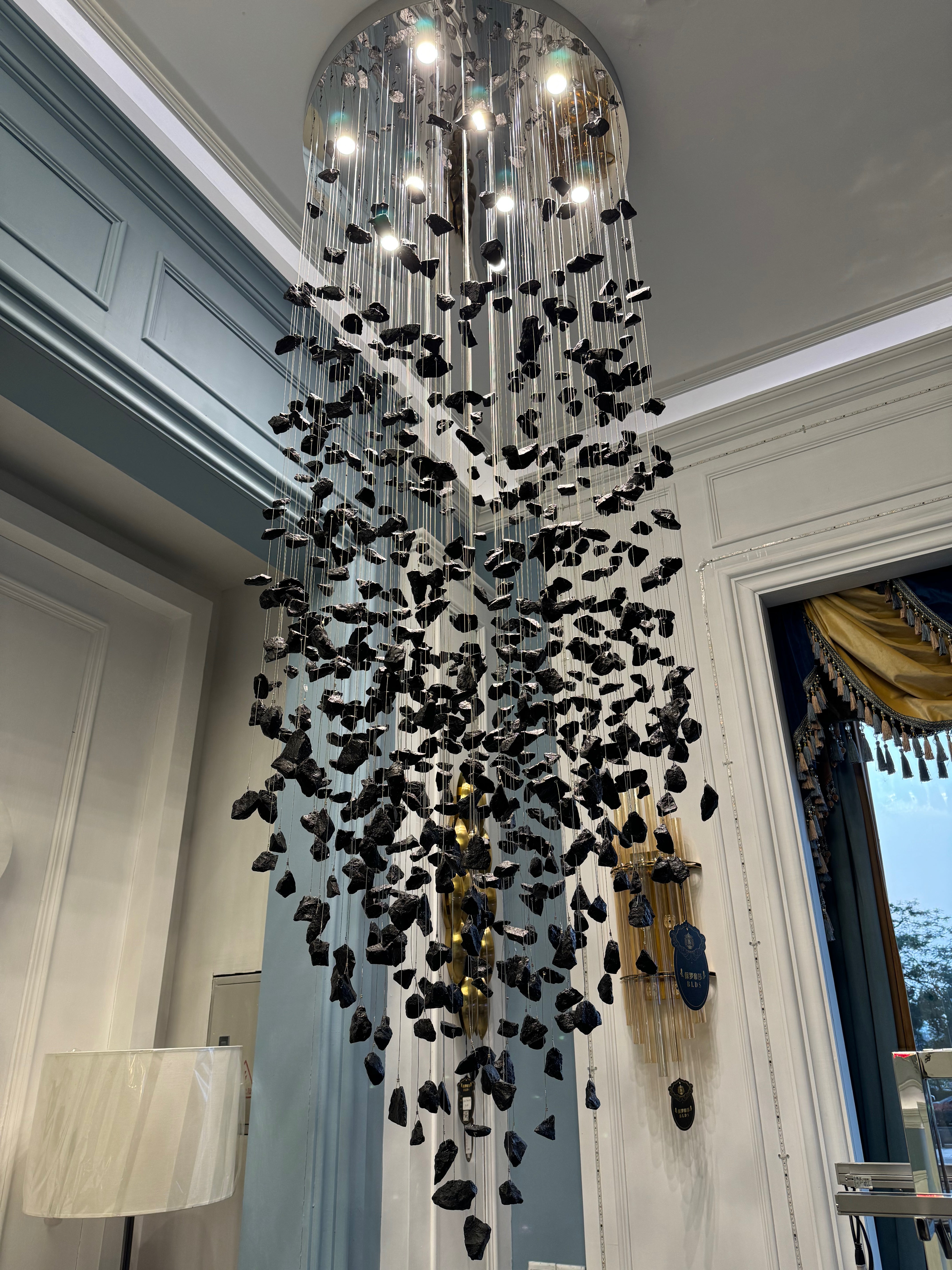 VORELLI Basilica pendant staircase chandelier with cascading black stone installation detail