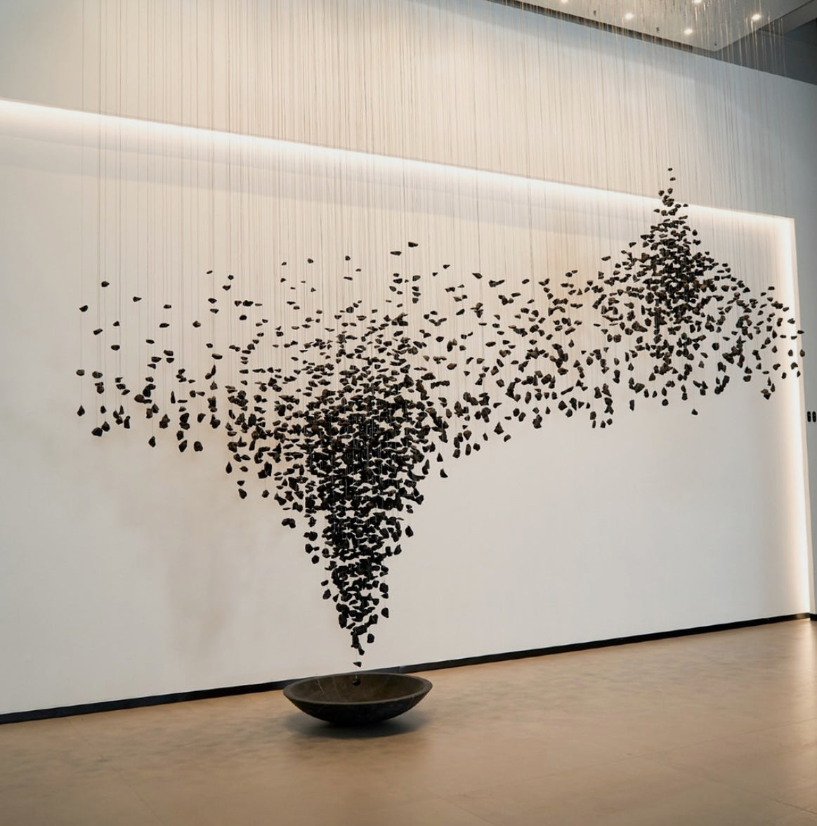 Basilica black stone pendant staircase chandelier installed in a luxury contemporary hospitality interior