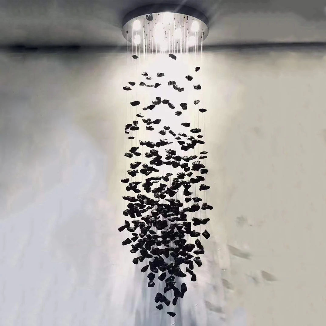 Close-up view of cascading pendant drops forming a sculptural staircase chandelier.