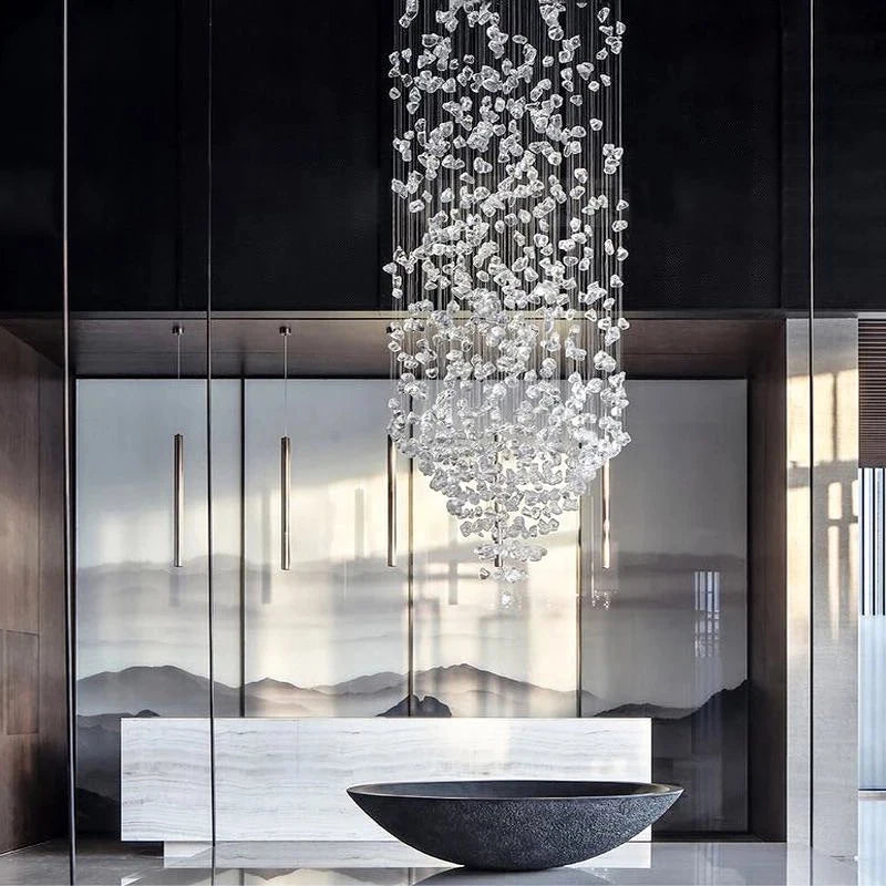 Luxury cascading staircase chandelier suspended above a contemporary dining space.