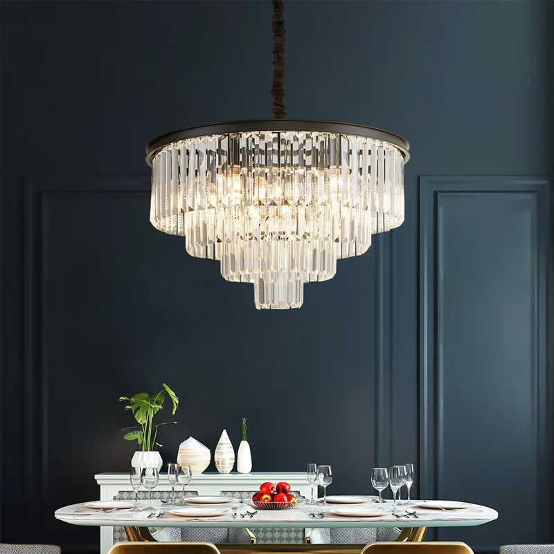 Luxury circular chandelier with cascading crystal bars above a modern dining table.