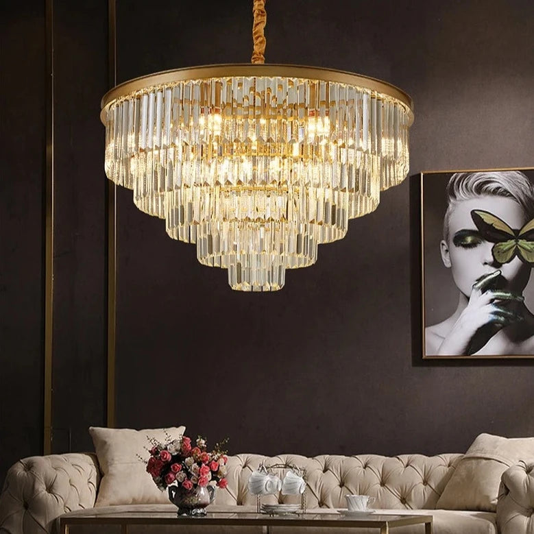 Circular chandelier with cascading crystal bars styled in a modern living interior.