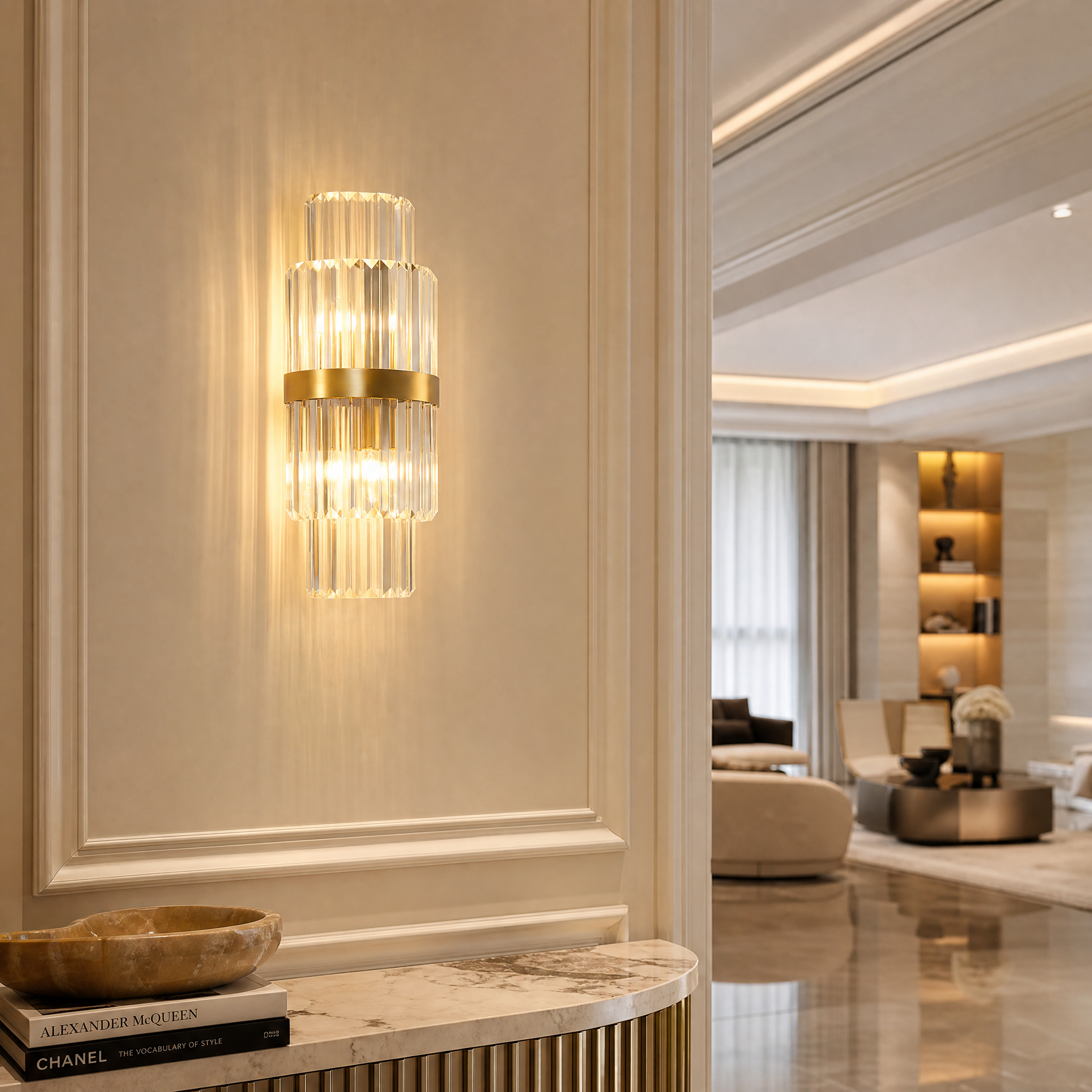 Luxurious VORELLI Belair crystal wall light illuminating an elegant residential living room interior with a sophisticated warm glow.