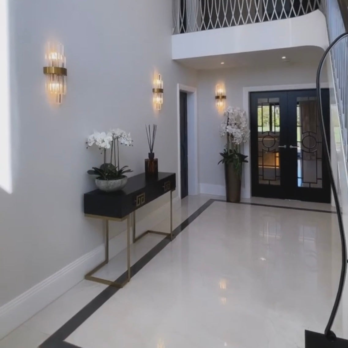 Elegant crystal wall light featured in a luxury entrance interior.