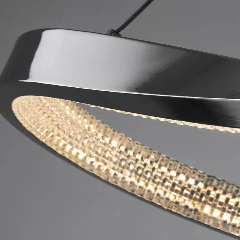 Close-up of the Belgravia chandelier’s sleek dark frame and sculptural contours.