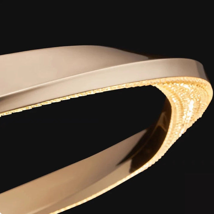 Detailed view of the twisted golden ribbon design on the Belgravia chandelier.