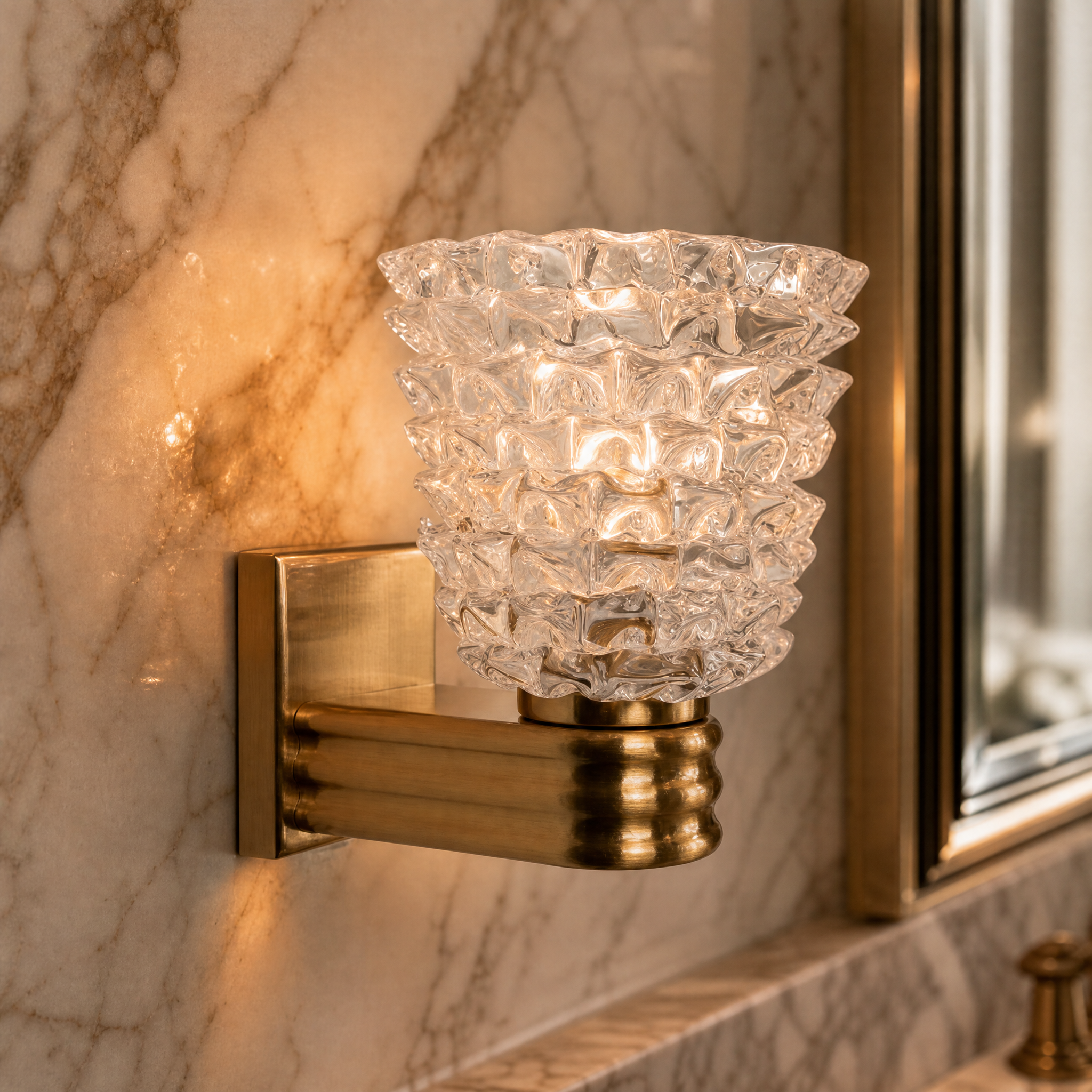 Macro closeup of the VORELLI Bellaria wall light highlighting the intricate texture of the spiked Murano-style glass and the solid brass base.