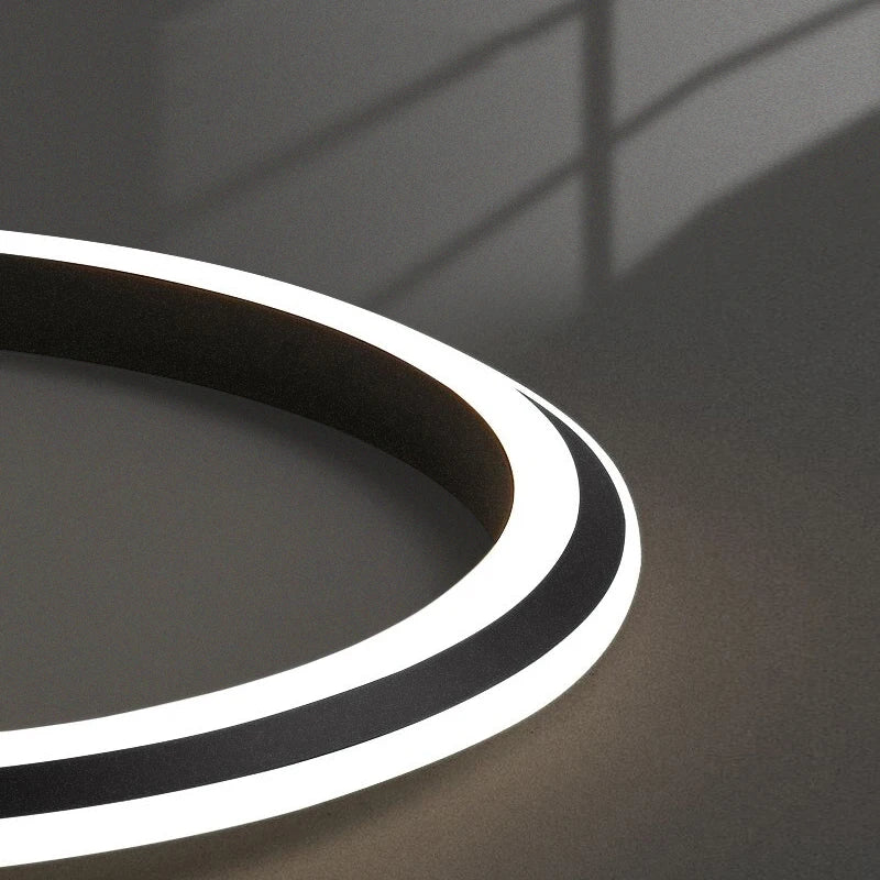 Abstract close-up showcasing the illuminated LED ring structure of the chandelier.