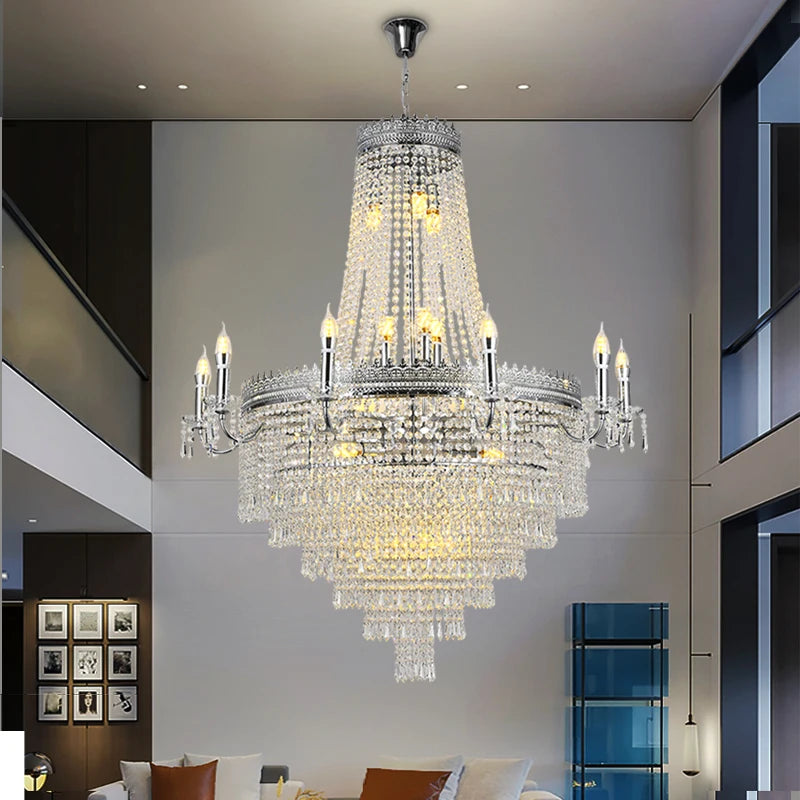 Grand multi-tier staircase chandelier with cascading crystal elements in a luxury foyer.