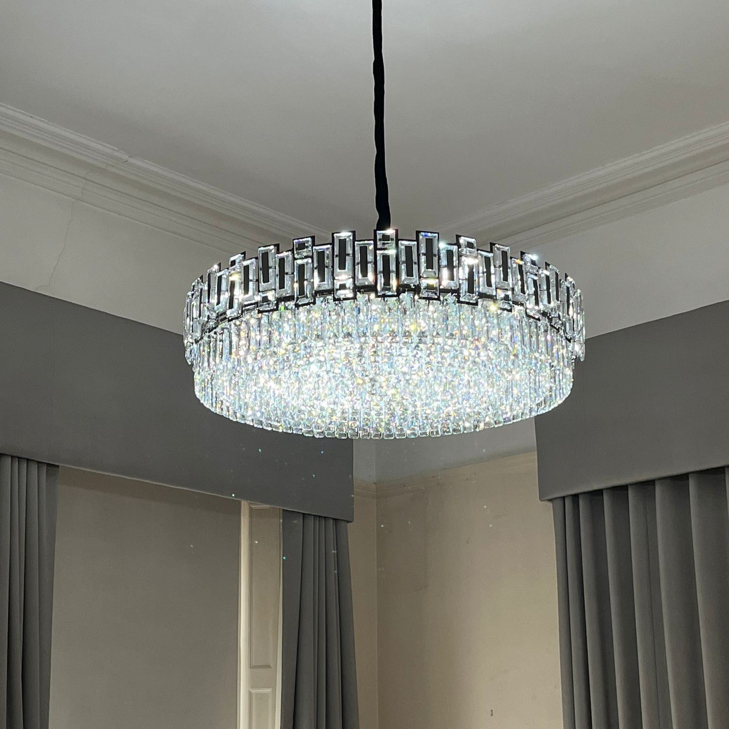 Elegant circular chandelier illuminating a sophisticated living area.