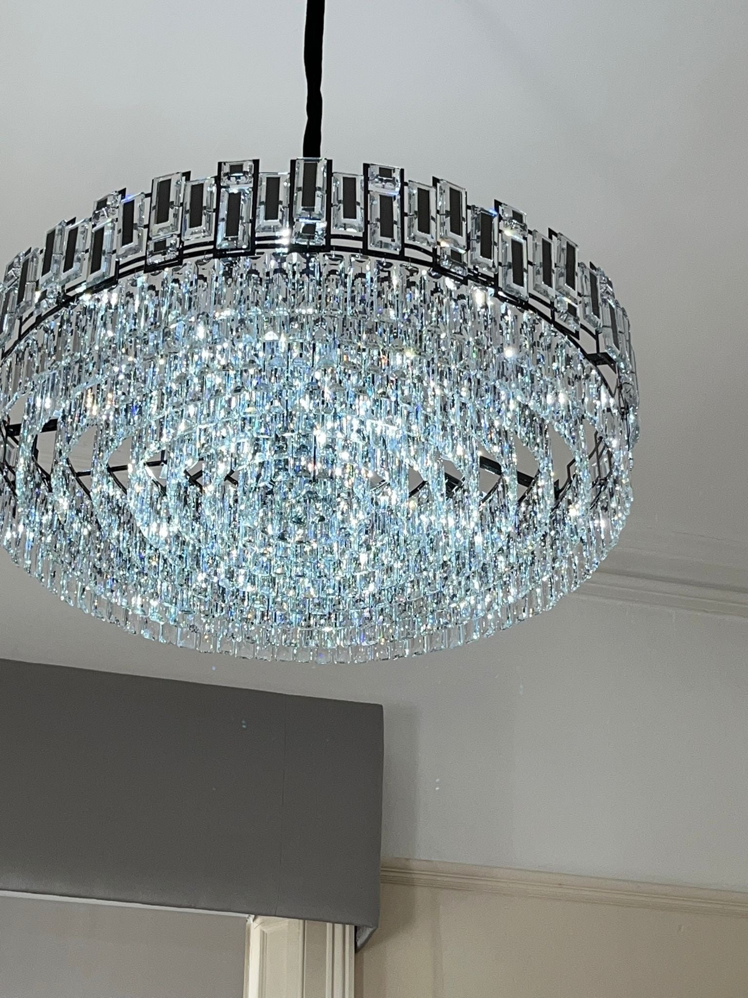 Close-up of the Belvedere circular crystal chandelier showcasing diamond cut faceted crystals in a luxury interior