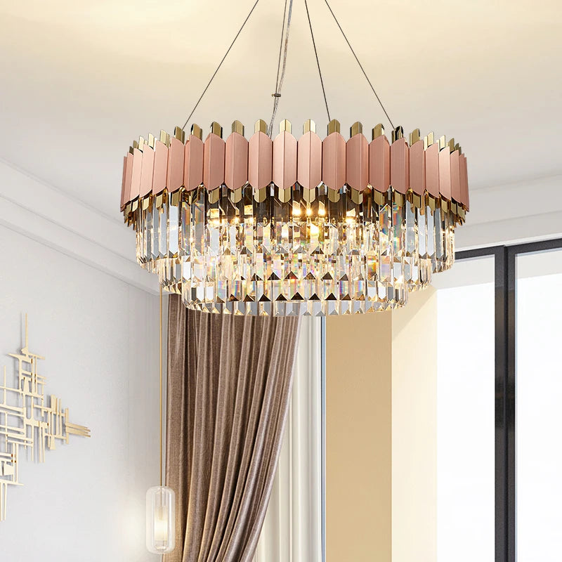Rose gold circular chandelier with pink-tinted crystal bars suspended in a modern room.