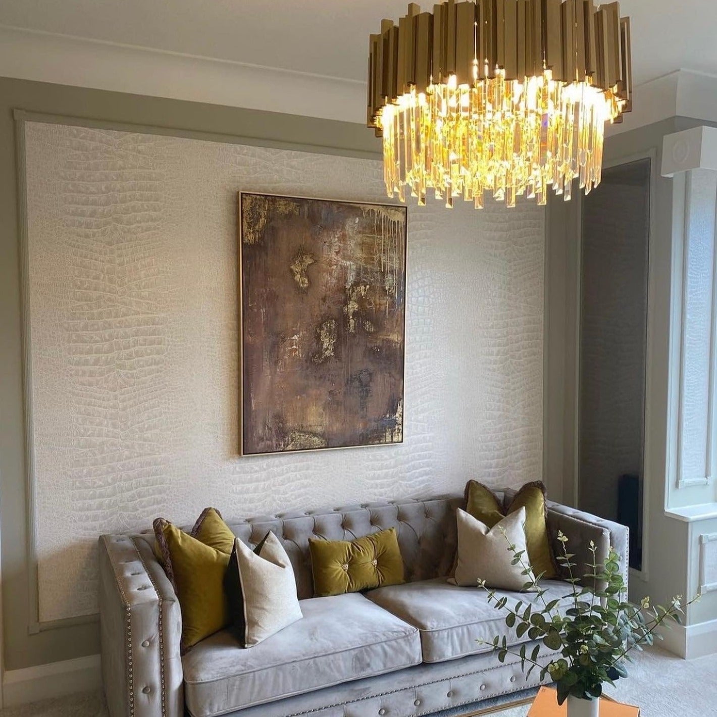 Boeotia circular chandelier adding a sophisticated glow to an upscale living room.