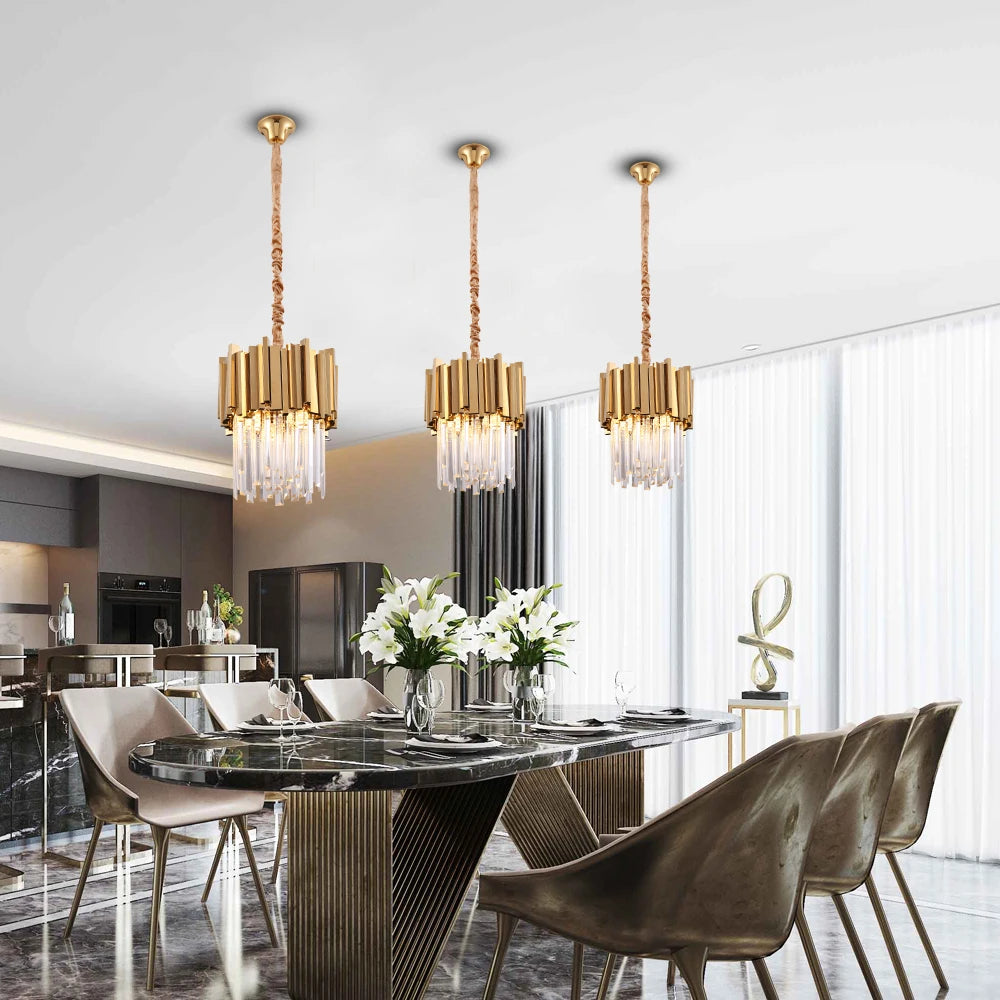 Boeotia Pendant with gold cuboid tubes and crystal bars hanging above a luxury dining table.