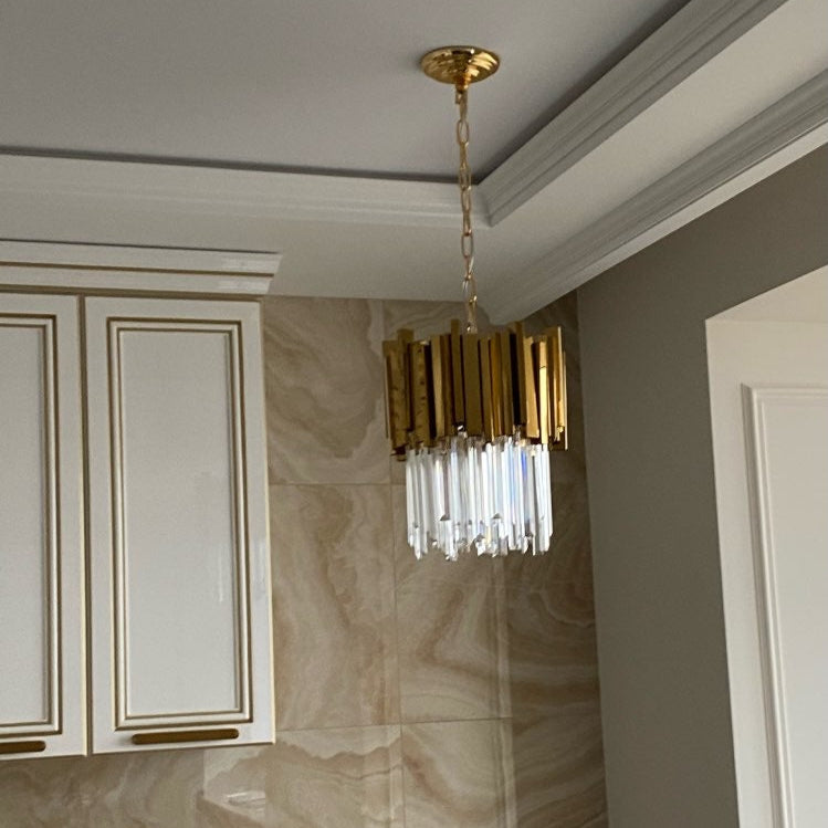 Macro view of the Boeotia Pendant’s gold cuboid tubing and crystal integration.